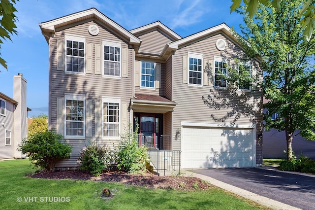 6542 Pine Hollow Rd, Carpentersville, IL 60110 - traditional-style house featuring driveway, a garage, and a front yard