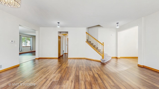 6542 Pine Hollow Rd, Carpentersville, IL 60110 - unfurnished living room featuring wood finished floors and stairs