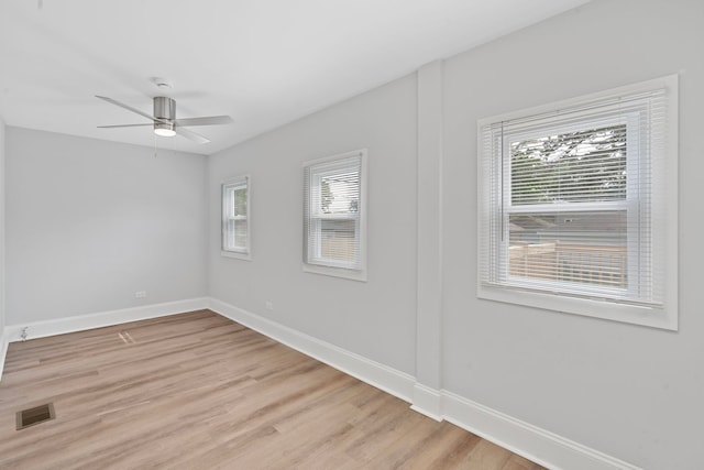 7827 S Calumet Ave, Chicago, IL 60619 - empty room with healthy amount of natural light, baseboards, light wood-type flooring, and a ceiling fan