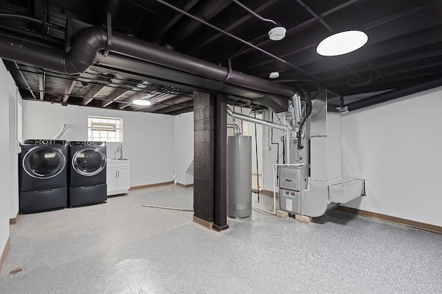 7827 S Calumet Ave, Chicago, IL 60619 - below grade area featuring separate washer and dryer, water heater, heating unit, baseboards, and a sink