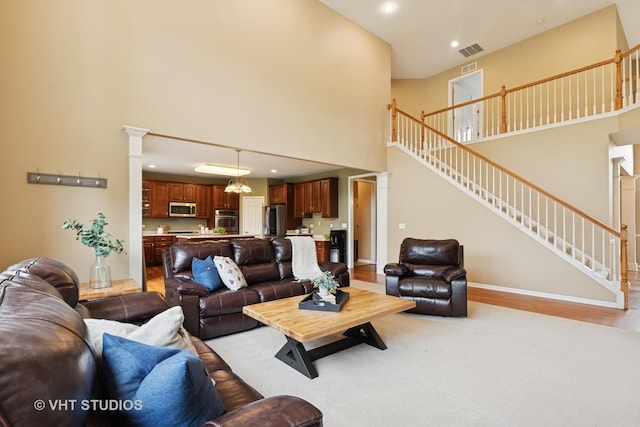 18861 W Aspen Ct, Lake Villa, IL 60046 - living room with a towering ceiling, stairway, recessed lighting, and ornate columns