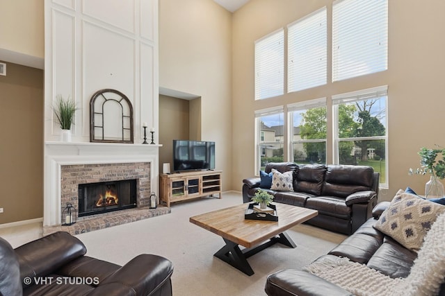 18861 W Aspen Ct, Lake Villa, IL 60046 - carpeted living area with a towering ceiling and a brick fireplace