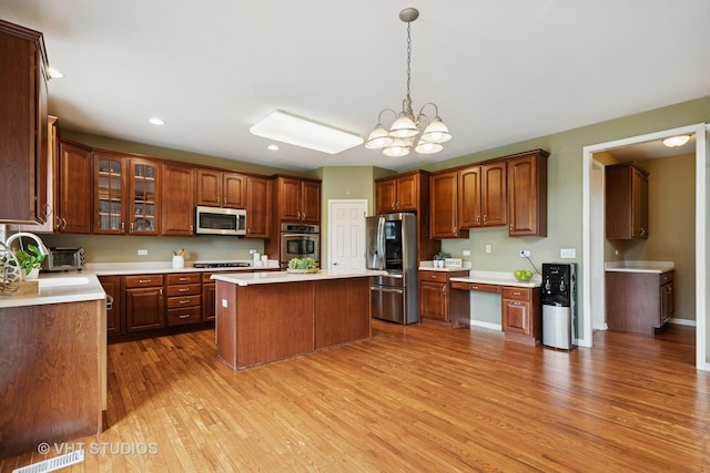 18861 W Aspen Ct, Lake Villa, IL 60046 - kitchen with stainless steel appliances, light wood-type flooring, a chandelier, light countertops, and recessed lighting
