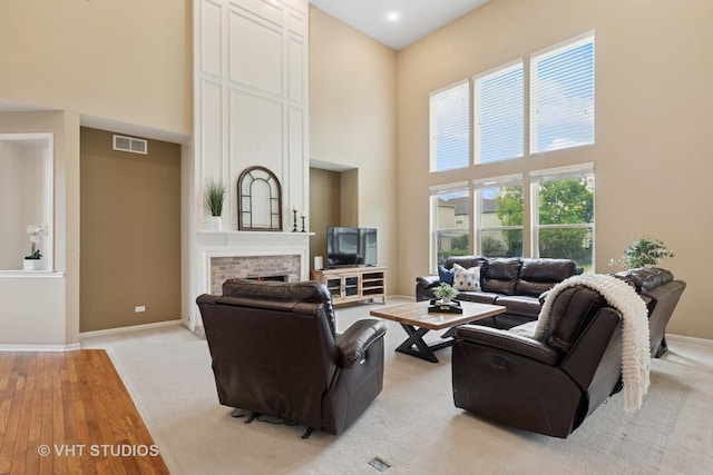 18861 W Aspen Ct, Lake Villa, IL 60046 - living room featuring a towering ceiling, light wood-style floors, and a brick fireplace