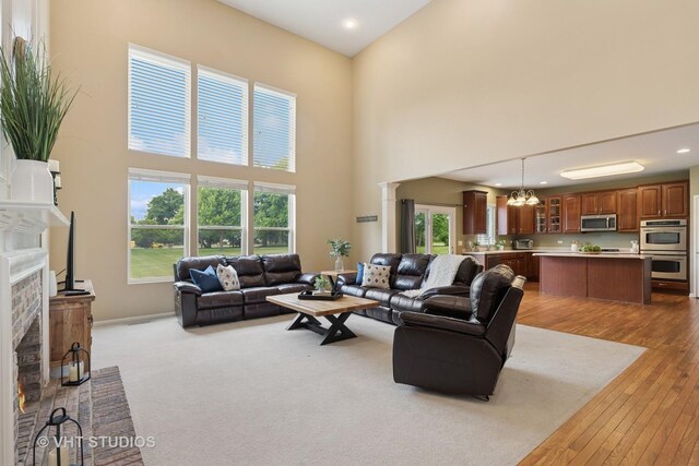 18861 W Aspen Ct, Lake Villa, IL 60046 - living room featuring a towering ceiling, decorative columns, a chandelier, plenty of natural light, and recessed lighting