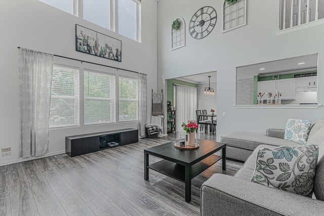 2367 Camden Bay, Elgin, IL 60123 - living room featuring wood finished floors, a high ceiling, and a chandelier