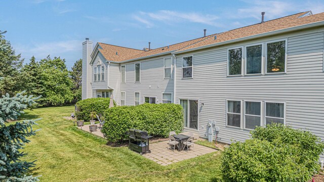2367 Camden Bay, Elgin, IL 60123 - rear view of house with a patio, a yard, and a chimney