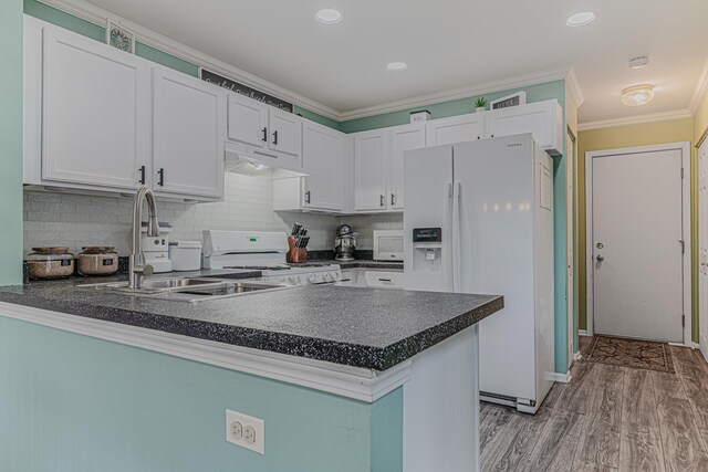 2367 Camden Bay, Elgin, IL 60123 - kitchen with white appliances, dark countertops, a peninsula, under cabinet range hood, and white cabinets