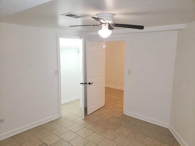 7127 S Eberhart Ave, Chicago, IL 60619 - empty room featuring ceiling fan, light tile patterned floors, and baseboards