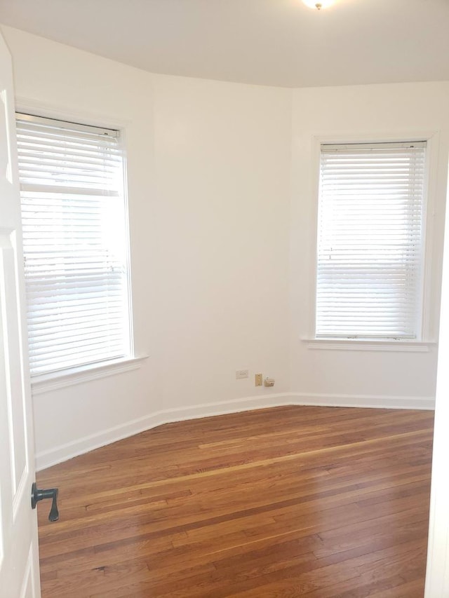 7127 S Eberhart Ave, Chicago, IL 60619 - empty room featuring wood finished floors and baseboards