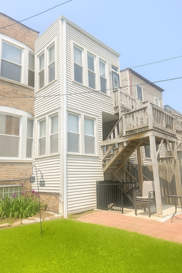 7127 S Eberhart Ave, Chicago, IL 60619 - rear view of property featuring a patio and stairs