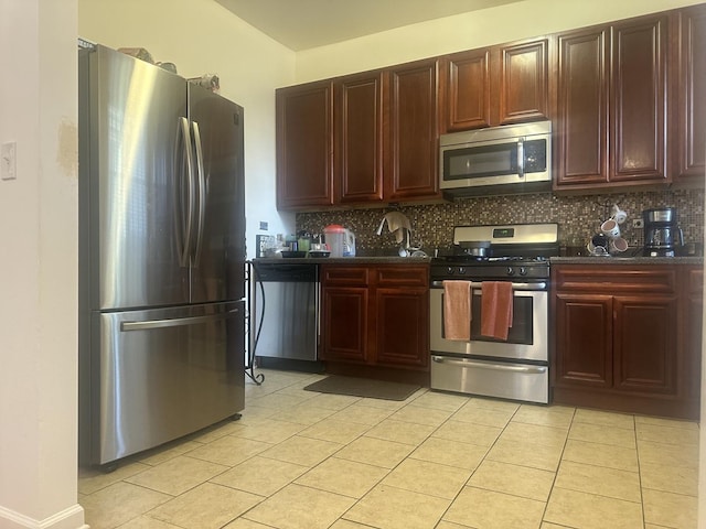 7127 S Eberhart Ave, Chicago, IL 60619 - kitchen featuring stainless steel appliances, light tile patterned floors, decorative backsplash, and reddish brown cabinets