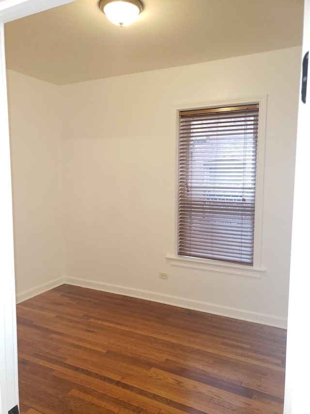 7127 S Eberhart Ave, Chicago, IL 60619 - empty room featuring dark wood-style flooring and baseboards