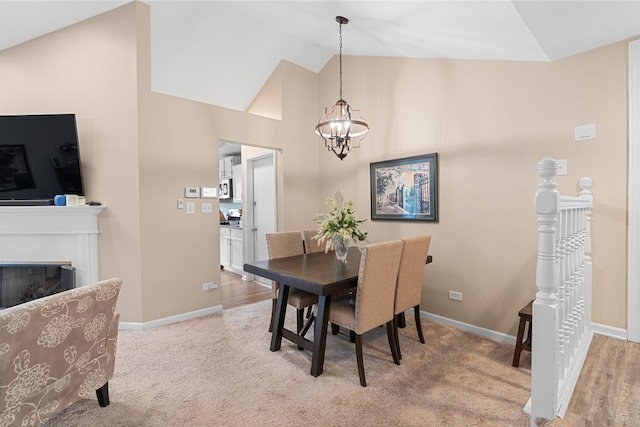 972 W Ct Unit C, Naperville, IL 60563 - dining space featuring vaulted ceiling, a chandelier, baseboards, and carpet flooring