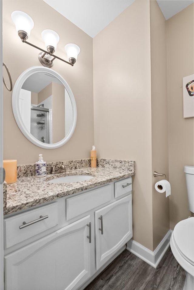 972 W Ct Unit C, Naperville, IL 60563 - full bath with vanity, toilet, wood finished floors, baseboards, and a shower with shower door