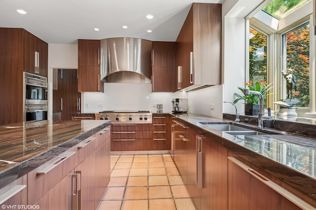 1242 Antietam Dr, Long Grove, IL 60047 - kitchen with appliances with stainless steel finishes, modern cabinets, wall chimney range hood, recessed lighting, and dark stone countertops