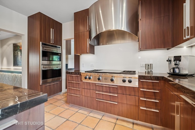 1242 Antietam Dr, Long Grove, IL 60047 - kitchen with wall chimney range hood, modern cabinets, stainless steel appliances, and light tile patterned floors