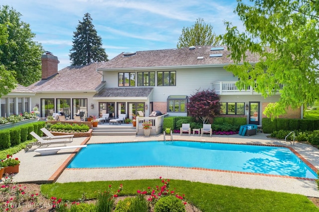 1242 Antietam Dr, Long Grove, IL 60047 - rear view of property with a patio area, an outdoor pool, and a chimney