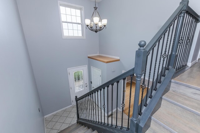 102 Merganser Ct, Downs, IL 61736 - staircase with a chandelier, baseboards, and wood finished floors