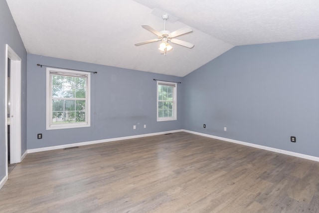 102 Merganser Ct, Downs, IL 61736 - spare room with vaulted ceiling, ceiling fan, wood finished floors, and baseboards