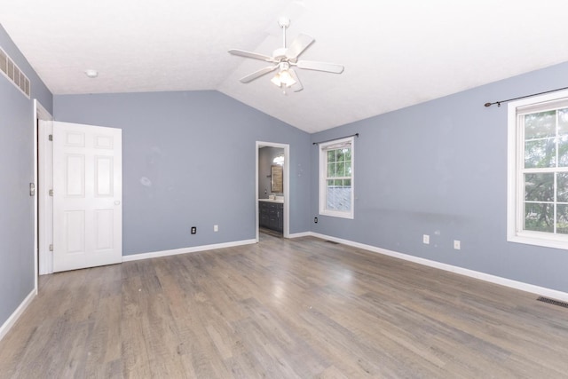 102 Merganser Ct, Downs, IL 61736 - unfurnished bedroom featuring lofted ceiling, wood finished floors, baseboards, ensuite bathroom, and ceiling fan