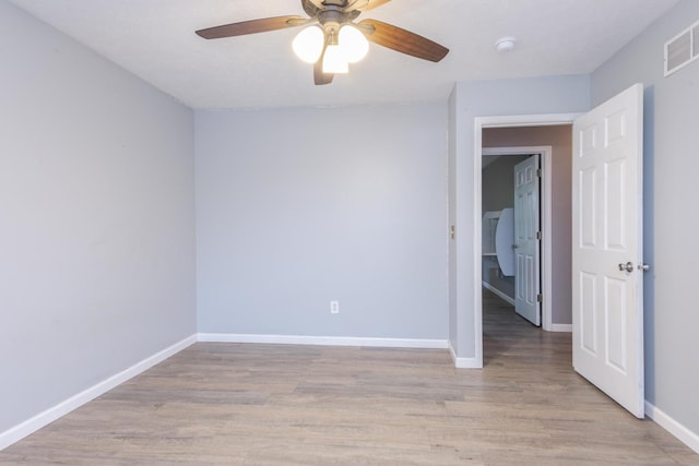 102 Merganser Ct, Downs, IL 61736 - empty room with baseboards, light wood-type flooring, a smoke detector, and a ceiling fan