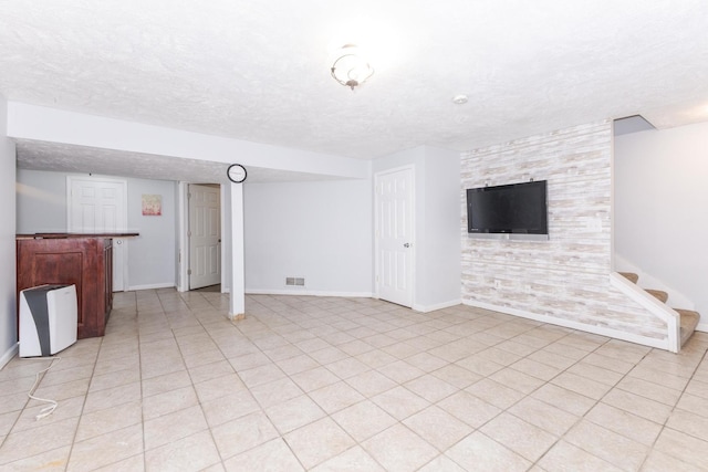 102 Merganser Ct, Downs, IL 61736 - unfurnished living room with baseboards, a textured ceiling, a dry bar, and stairs