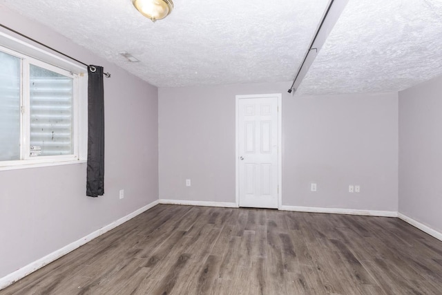 102 Merganser Ct, Downs, IL 61736 - bonus room with a textured ceiling, wood finished floors, and baseboards