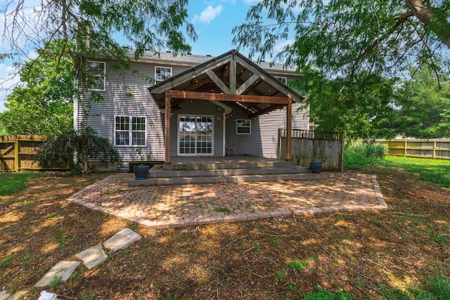 102 Merganser Ct, Downs, IL 61736 - rear view of house with a patio, a fenced backyard, and a deck