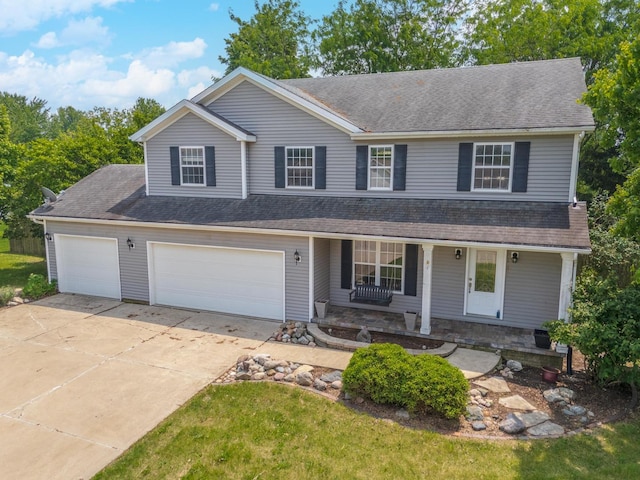 102 Merganser Ct, Downs, IL 61736 - view of front of property featuring covered porch, driveway, roof with shingles, and a garage