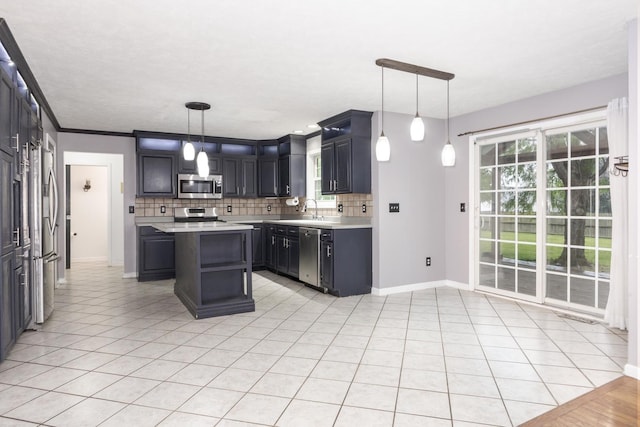 102 Merganser Ct, Downs, IL 61736 - kitchen with stainless steel appliances, light countertops, backsplash, baseboards, and a center island