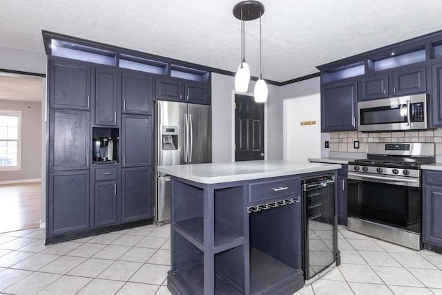 102 Merganser Ct, Downs, IL 61736 - kitchen with stainless steel appliances, beverage cooler, light countertops, decorative backsplash, and hanging light fixtures