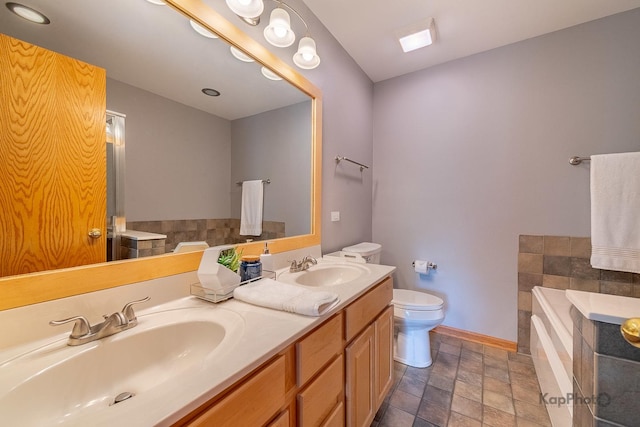 155 Willow Blvd, Willow Springs, IL 60480 - bathroom with toilet, a garden tub, double vanity, baseboards, and stone finish flooring