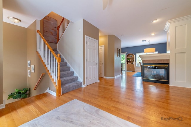 155 Willow Blvd, Willow Springs, IL 60480 - unfurnished living room featuring light wood-style flooring, stairs, baseboards, and a multi sided fireplace