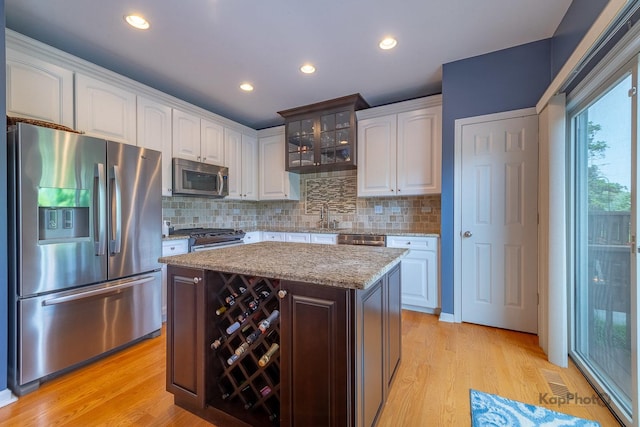 155 Willow Blvd, Willow Springs, IL 60480 - kitchen featuring stainless steel appliances, white cabinetry, tasteful backsplash, light wood-style flooring, and recessed lighting