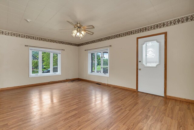 302 Wabash Ave, Campus, IL 60920 - spare room with light wood-style floors, ceiling fan, and baseboards