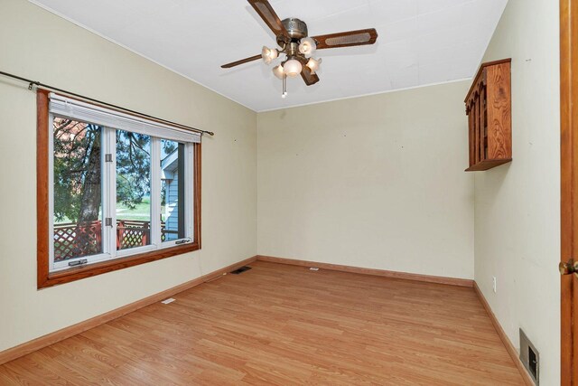 302 Wabash Ave, Campus, IL 60920 - spare room with light wood-style flooring, ceiling fan, and baseboards