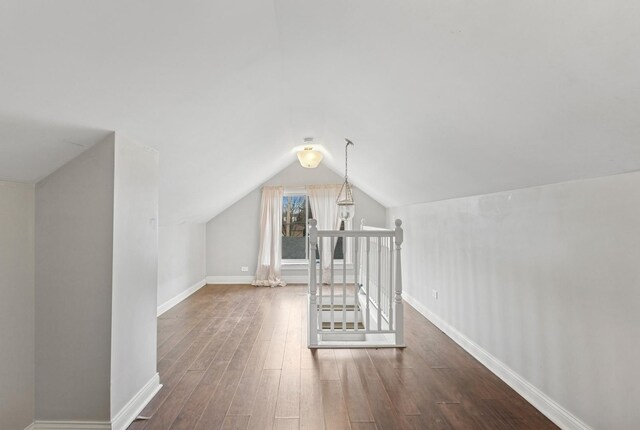 3731 Maple Ave, Berwyn, IL 60402 - additional living space with dark wood finished floors, vaulted ceiling, and baseboards