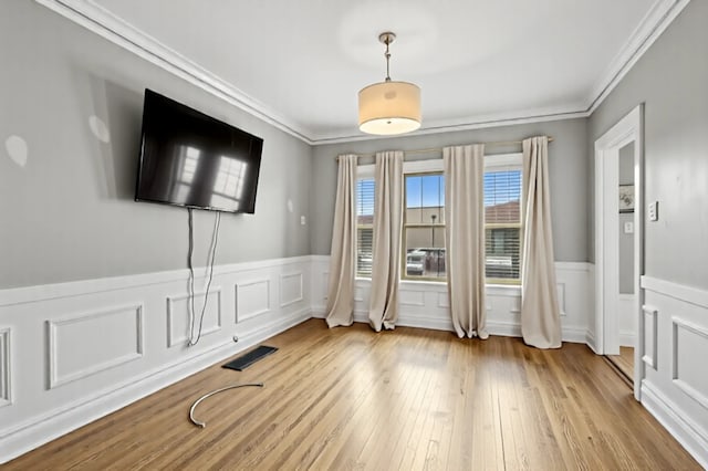 3731 Maple Ave, Berwyn, IL 60402 - empty room with wainscoting, crown molding, and wood finished floors