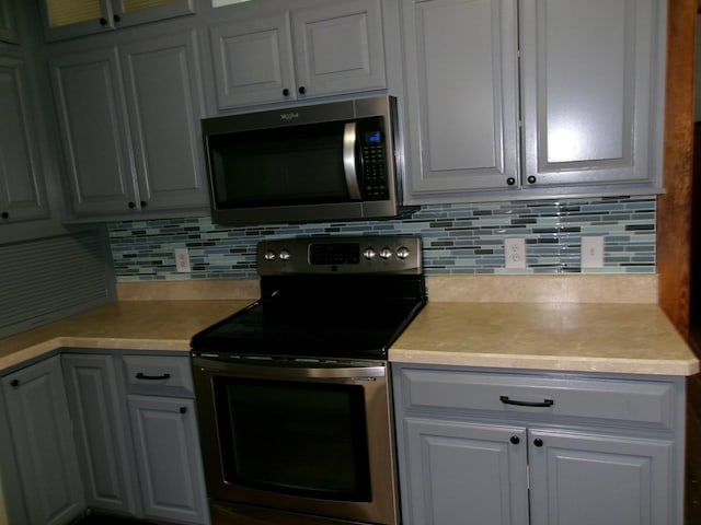 1023 Rock St, Peru, IL 61354 - kitchen featuring appliances with stainless steel finishes, light countertops, and tasteful backsplash