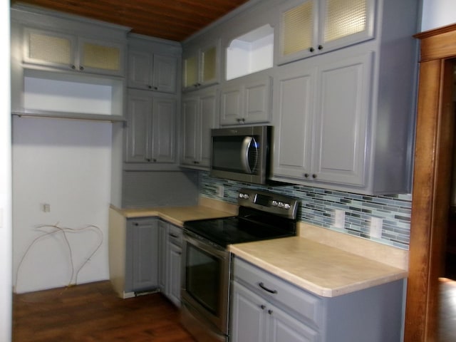 1023 Rock St, Peru, IL 61354 - kitchen featuring appliances with stainless steel finishes, light countertops, wooden ceiling, dark wood finished floors, and tasteful backsplash