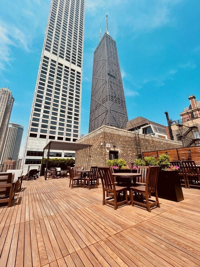 210 E Pearson St Unit 11A, Chicago, IL 60611 - wooden deck with outdoor dining area