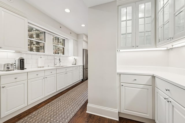 210 E Pearson St Unit 11A, Chicago, IL 60611 - bar area featuring freestanding refrigerator, decorative backsplash, dark wood-style flooring, recessed lighting, and a sink