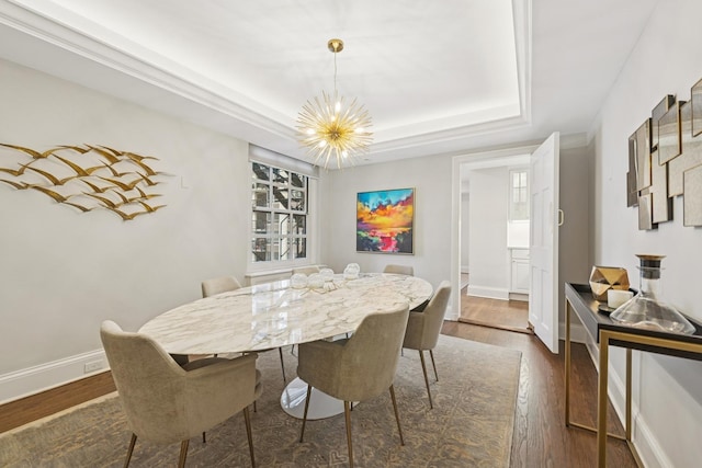 210 E Pearson St Unit 11A, Chicago, IL 60611 - dining room with a chandelier, dark wood-type flooring, a raised ceiling, and baseboards