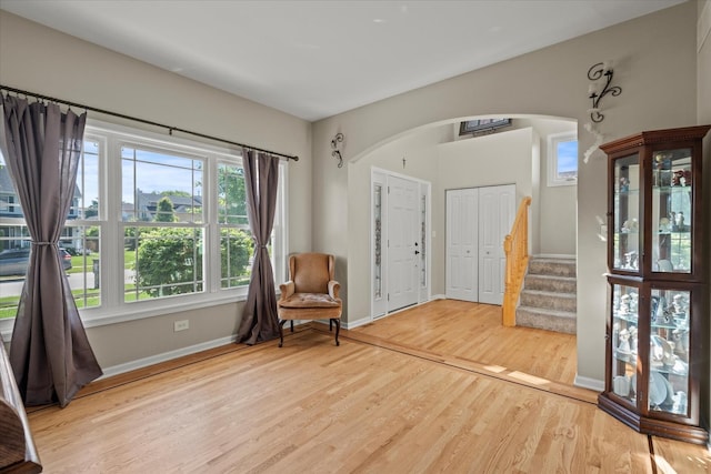 1809 Pembrook Ct, Plainfield, IL 60586 - living area with arched walkways, wood finished floors, stairs, and baseboards