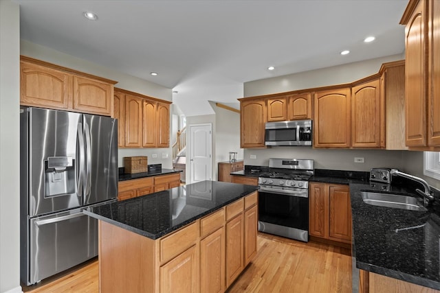 1809 Pembrook Ct, Plainfield, IL 60586 - kitchen with appliances with stainless steel finishes, a sink, dark stone countertops, light wood finished floors, and a center island