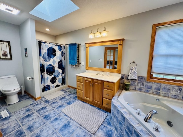 1102 Brian Dr, Manteno, IL 60950 - bathroom featuring a skylight, toilet, vanity, a bath, and a shower with shower curtain