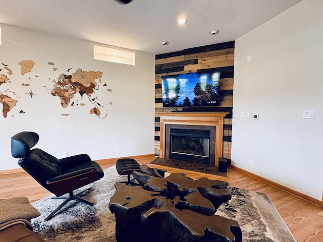 1102 Brian Dr, Manteno, IL 60950 - living room featuring a fireplace, wood finished floors, baseboards, a textured ceiling, and built in shelves