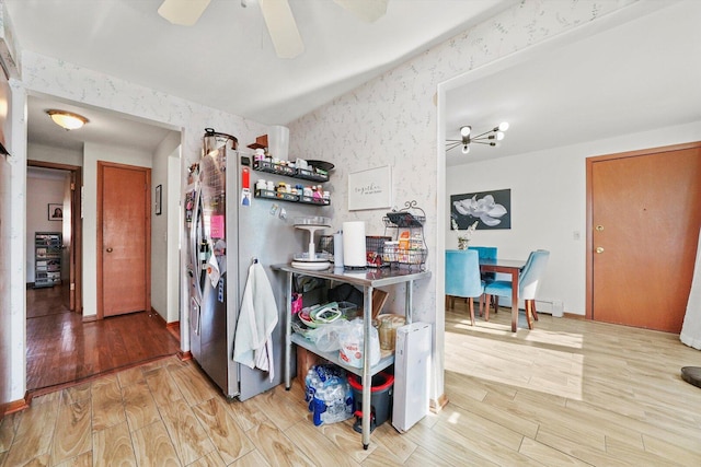 6568 W Roscoe St Unit 2N, Chicago, IL 60634 - kitchen with wallpapered walls, wood finished floors, ceiling fan, and freestanding refrigerator