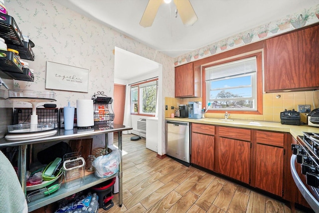 6568 W Roscoe St Unit 2N, Chicago, IL 60634 - kitchen with dishwasher, a sink, wallpapered walls, light countertops, and range